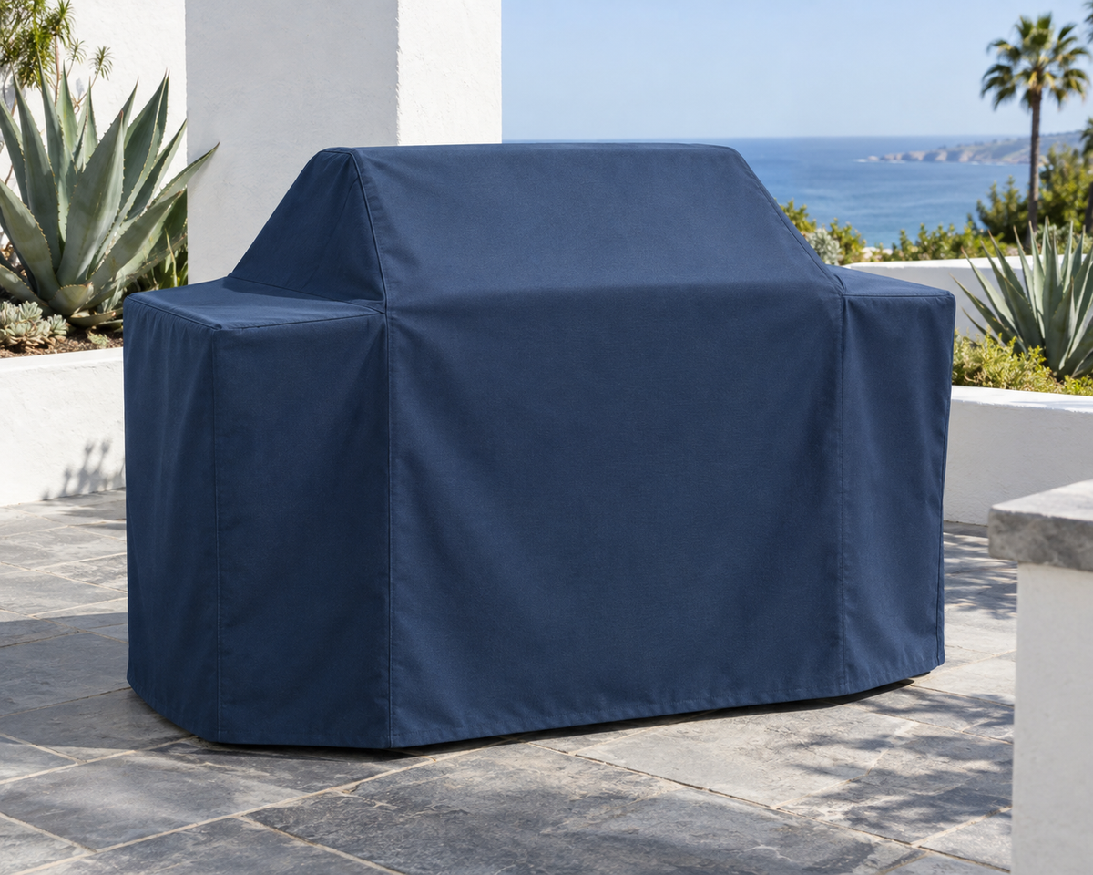 Marine Blue example of a fitted cover over a cart-style grill on a sunny patio