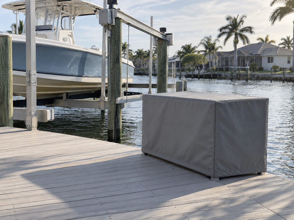 Gray fitted cover on a low outdoor cabinet at a dock