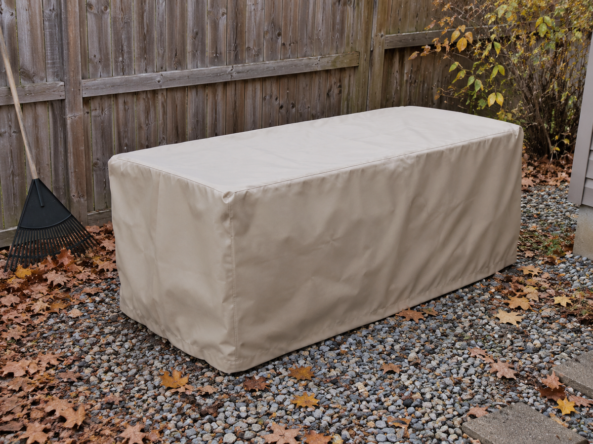 Tan storage box cover beside autumn leaves and a garden fence