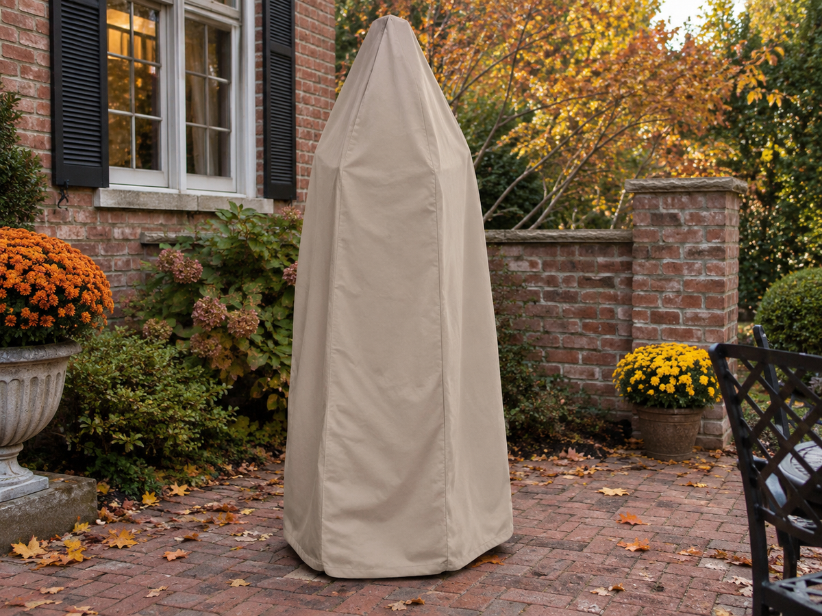 Tan custom cover over a tall outdoor fountain on a brick patio in autumn